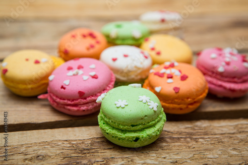 colored French macaroons on a wooden table