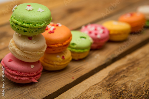 colored French macaroons on a wooden table