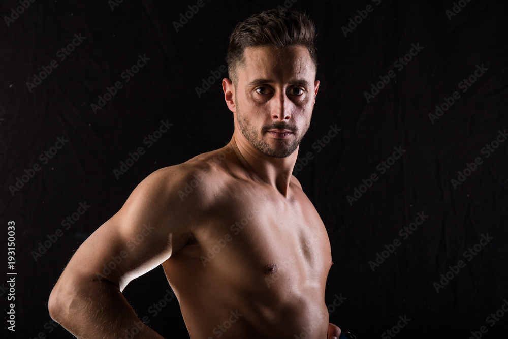 Fitness session in madrid's photographic studio with a boy without a shirt