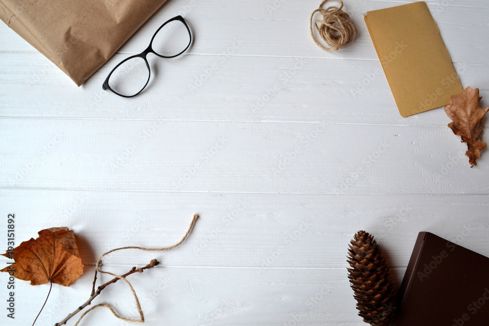 Craft paper, rope, box and eyeglasses on the white wooden background. Workshop tools. Craft paper, rope, box and eyeglasses on the white wooden background. Workshop tools.