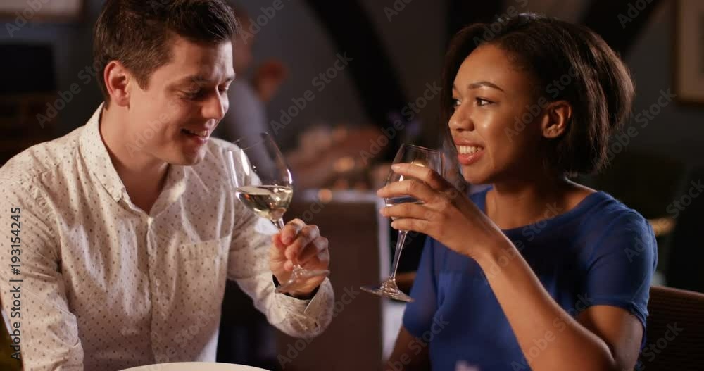 4K Romantic couple on date night raise their wine glasses for a toast 4K Romantic couple on date night raise their wine glasses for a toast