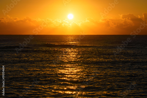 Golden beach sunrise or sunset over the sea