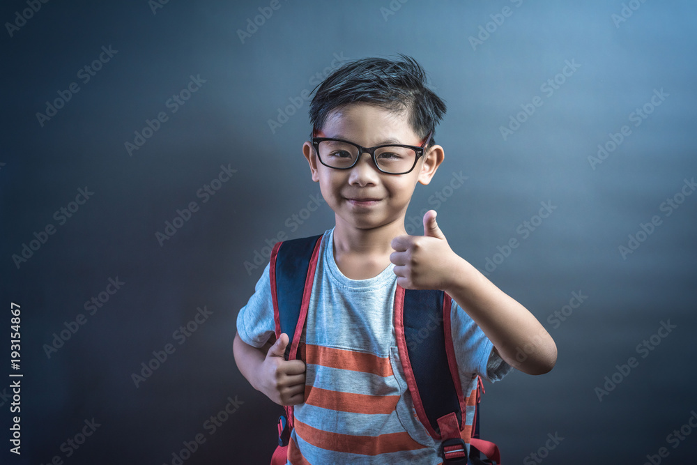 asian kid with thumbs up agreeing and giving his approval.portrait of ...