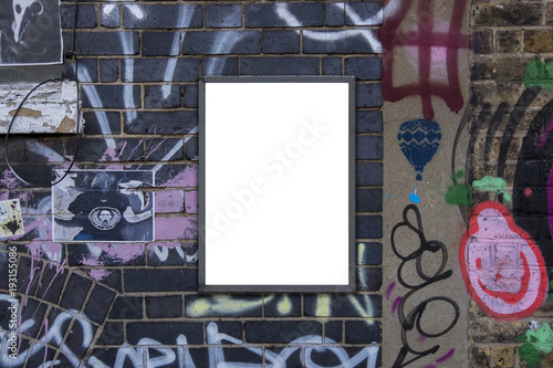 Blank notice advertising poster for mockup on painted graffiti covered brick wall