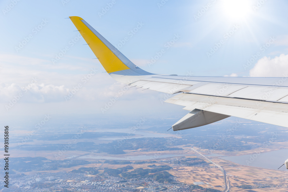 Fototapeta premium plane wing flying over earth landscape view background