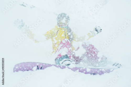 Snowy photo of woman with snowboard on winter mountain slope