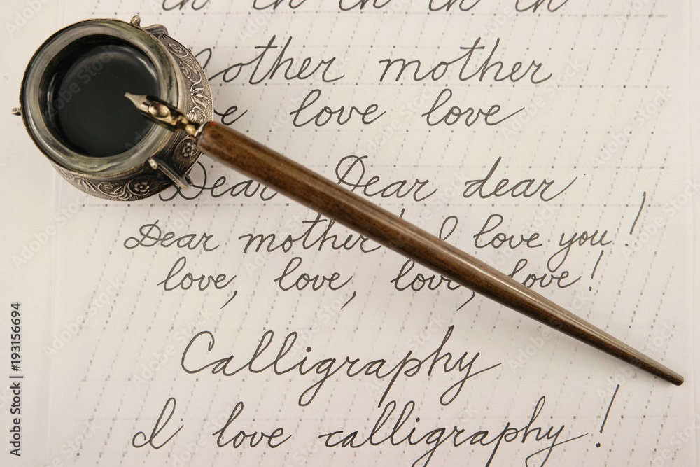 Handle and inkwell with black ink on calligraphy background Handle and inkwell with black ink on calligraphy background