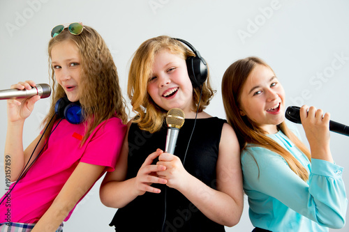 Girls singing in headphones