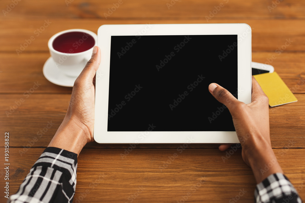 Black woman pointing with finger on digital tablet Black woman pointing with finger on digital tablet