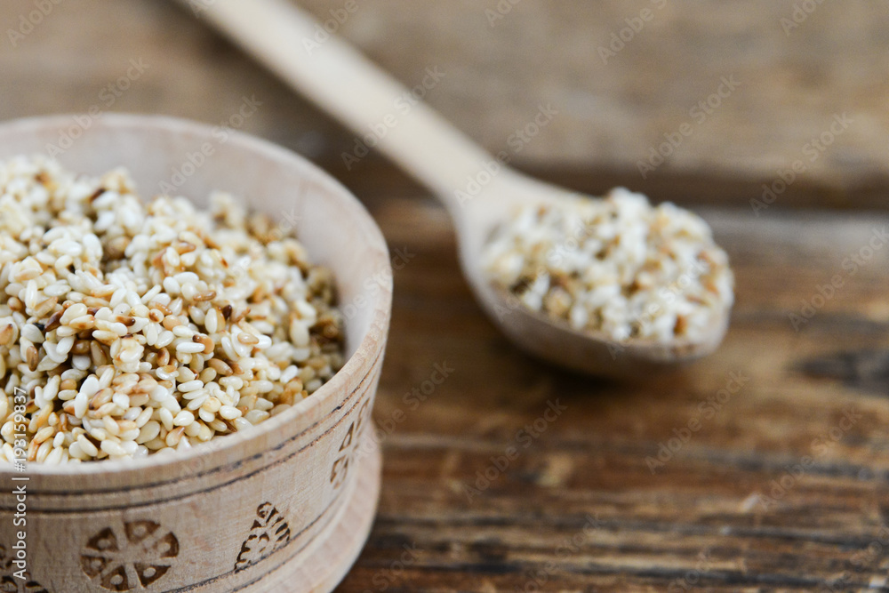 white sesame seed, sesame seed in wooden Cup on natural wooden background in rustic style white sesame seed, sesame seed in wooden Cup on natural wooden background in rustic style