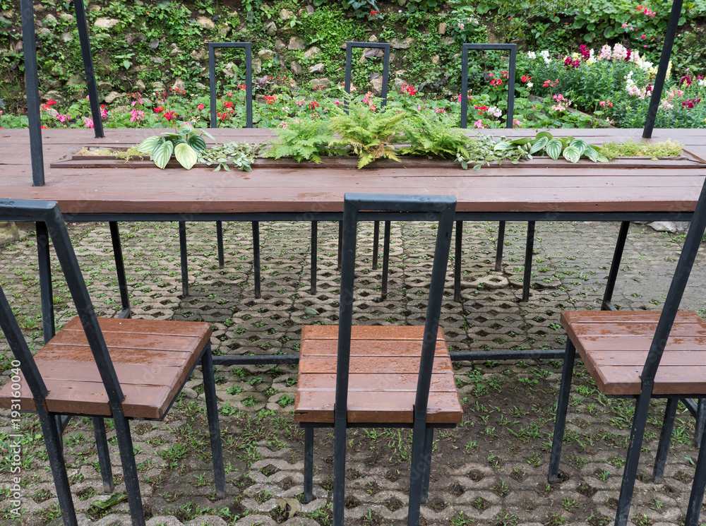 Metal frame table and chari set in the flower garden.