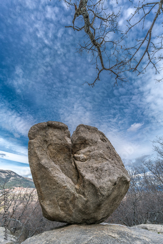Celtic Vetton sacred place (Nemeton), Large boulder of granite rock surounded by trees at Silla de Felipe II (Phillip II chair) in Guadarrama Mountains near San Lorenzo del Escorial, Madrid, Spain photo