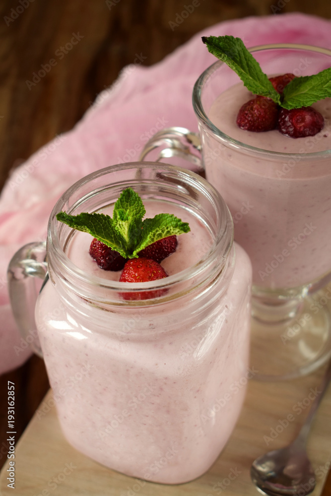 Protein cocktail with strawberries and mint in a glass jar Protein cocktail with strawberries and mint in a glass jar