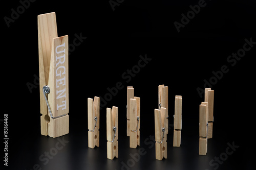 urgent clothespin issued commands isolated on black photo