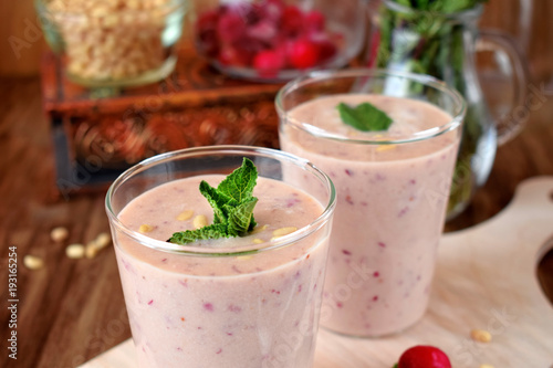 Protein cocktail for healthy nutrition with cranberries  mint and pine kernel nuts in a glass