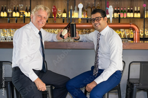 Two Business Leaders Celebrating Good Deal in Bar photo
