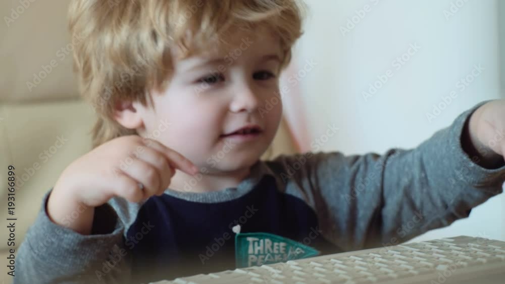 Little baby boy sitting with Laptop looking cartoons. Little boy learning to type on keyboard. Little baby boy sitting with Laptop looking cartoons. Little boy learning to type on keyboard.