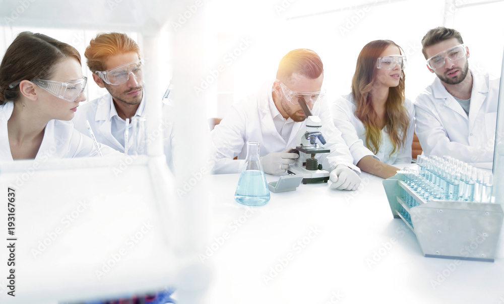 background image is a group of scientists working in the laboratory. background image is a group of scientists working in the laboratory.
