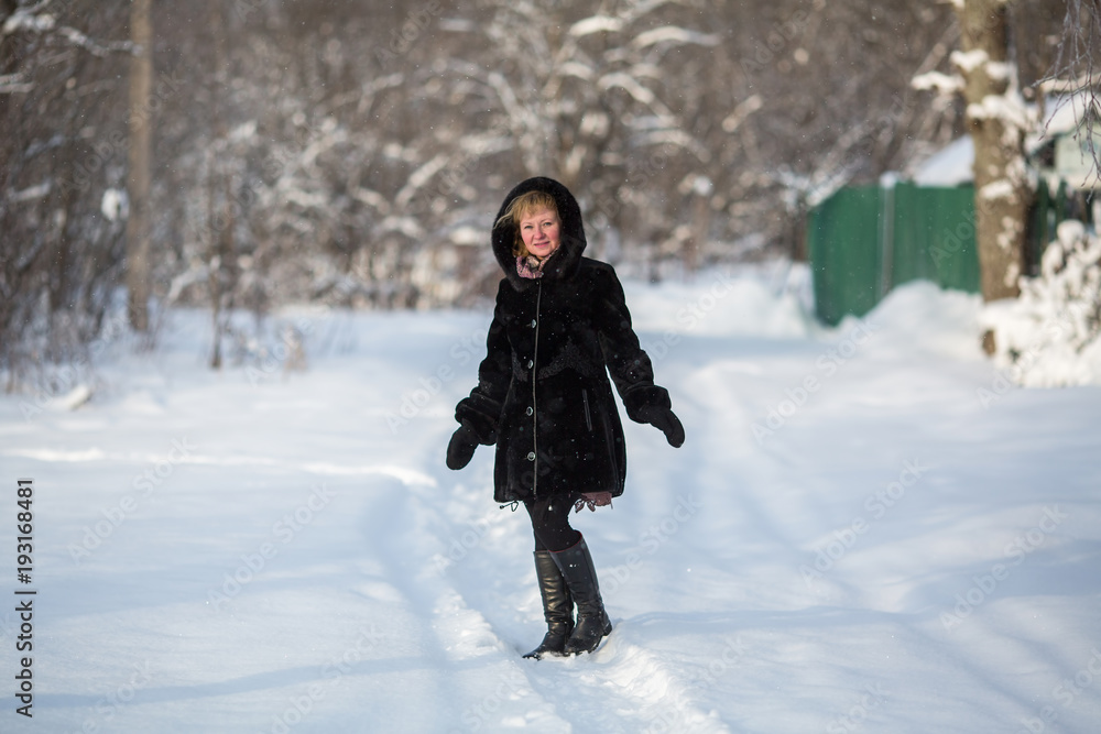 Young russian woman posing in the winter at snowy park. Young russian woman posing in the winter at snowy park.