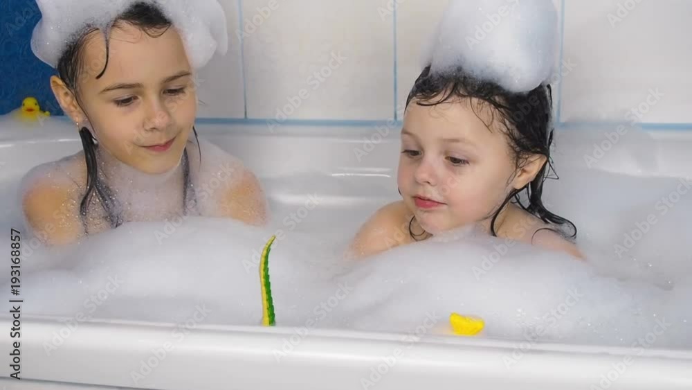 Children take a bath. Little girls are playing in the bathroom. Stock ビデオ | Adobe Stock