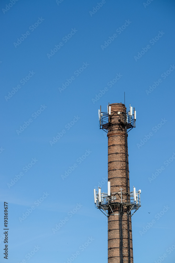 Old brick chimney turn into cellular tower.