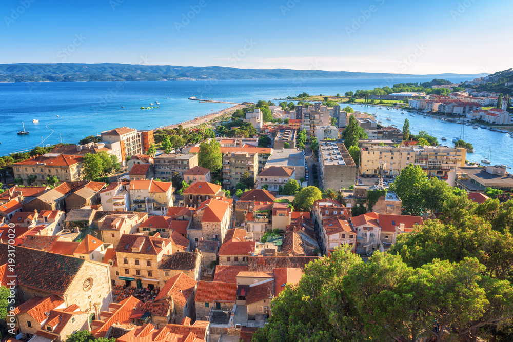 Panoramic view of Omis old town, blue sea, sky and island Brac from Mirabella (Peovica) fortress, mediterranean tourist resort in Dalmatia, Croatia