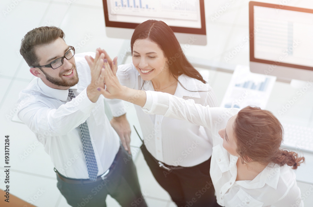 Fototapeta premium successful business team giving each other a high five .