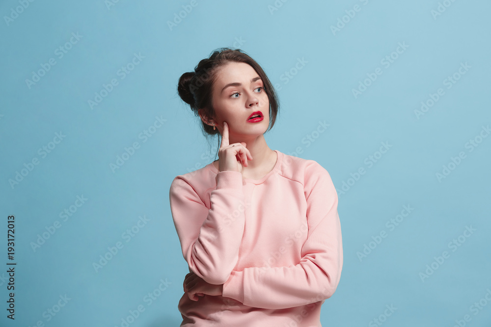 Fototapeta premium Young serious thoughtful business woman. Doubt concept.