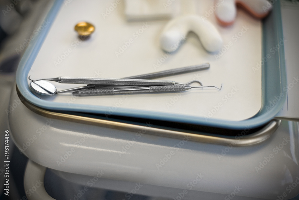 Dentist equipment lying on top of a medical tray. Dentist equipment lying on top of a medical tray.