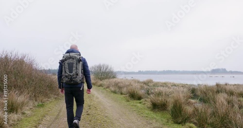 man traveling and hiking in nordic nature by lakes and in forest photo