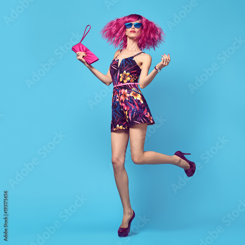 Full-length portrait Fashion woman Dance. Glamour Beautiful Lady. Party fashionable Hairstyle. Young female model with Pink Hair in Stylish fashion Outfit. Trendy Sunglasses, Heels
