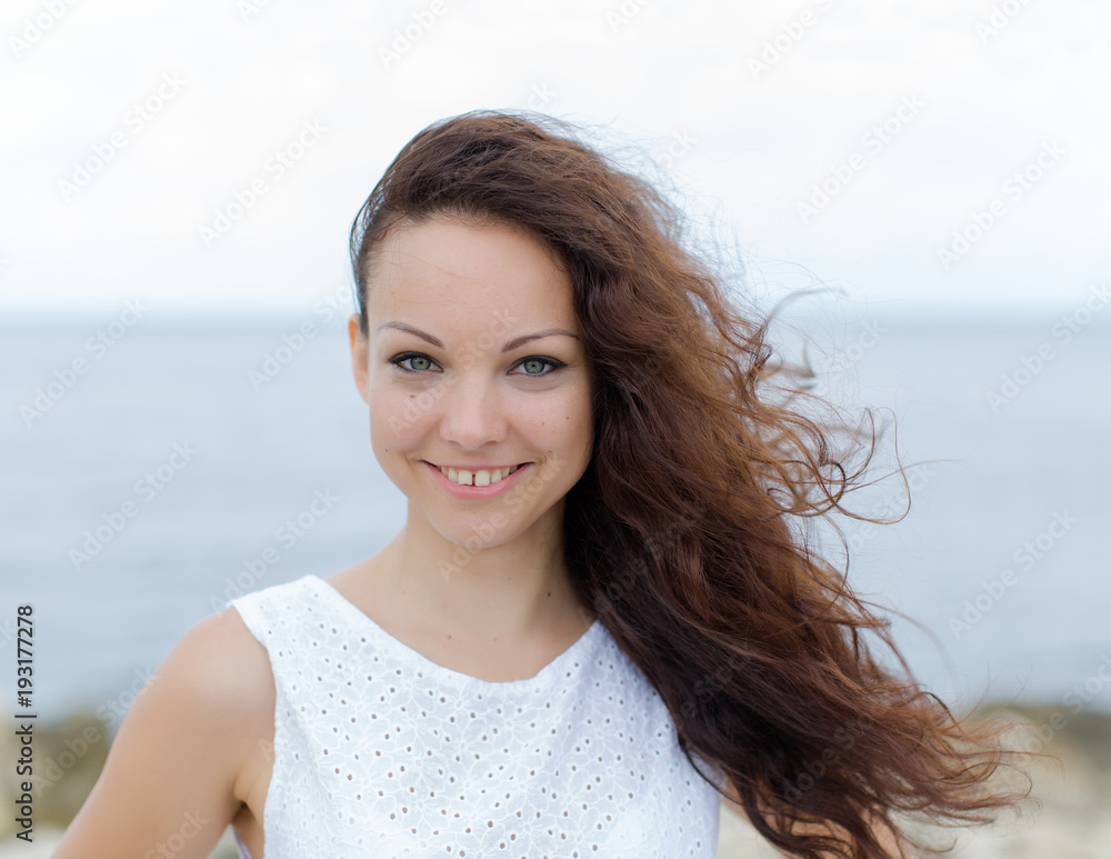 Portrait of girl with curly hair and gap between teeth