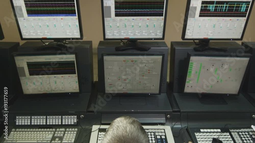 Worker Presses Keys on Keyboard on Control Panel photo