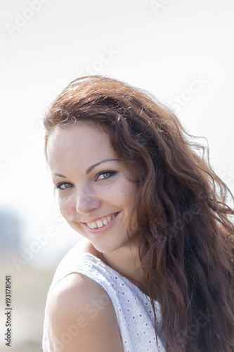 Portrait of cute girl in white outdoors