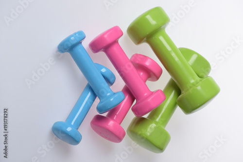 Dumbbells made of blue, pink and green plastic