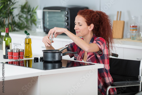 disabled woman cooking in her kitchen