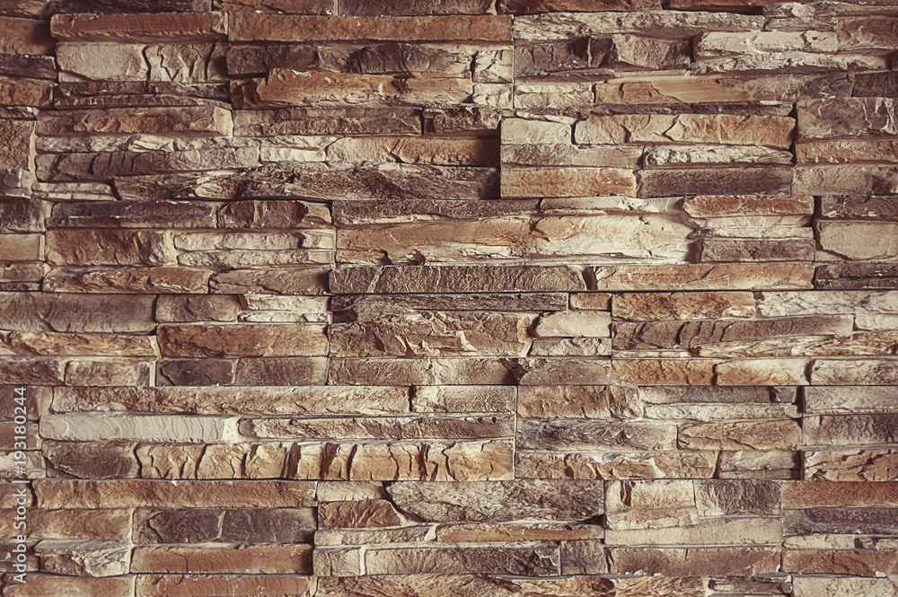 Naklejka premium Old brown stone wall background texture
