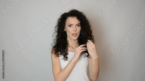 beautiful girl brunette with curly hair dry and damaged hair concept magnifier and com concept