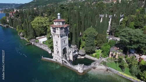 castle. Panorama of the gorgeous Lake Garda surrounded by mountains, Italy. video shooting with drone