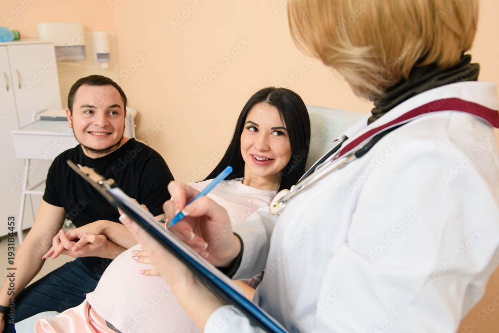 Happy couple expecting baby visit doctor Happy couple expecting baby visit doctor