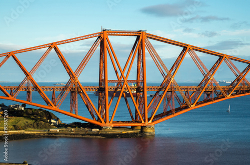 A view from the east footpath of the Forth Road Bridge, looking over North Queensferry harbour towords one of the towers of the old and famous Rail Bridge. © clivewa