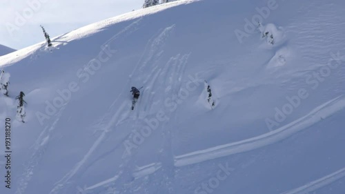 Skier wipes out after going off ski jump, slow motion