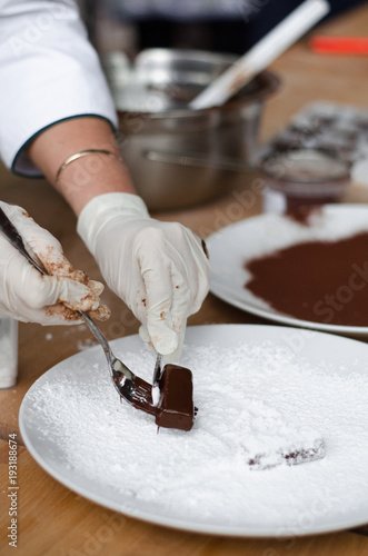 cooking homemade chocolates in chocolate glaze in the workshop. Master Class