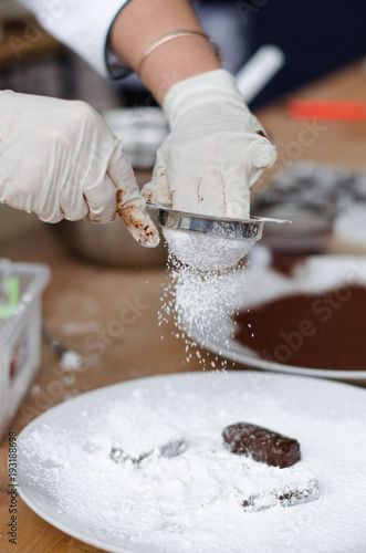 cooking homemade chocolates in chocolate glaze in the workshop. Master Class