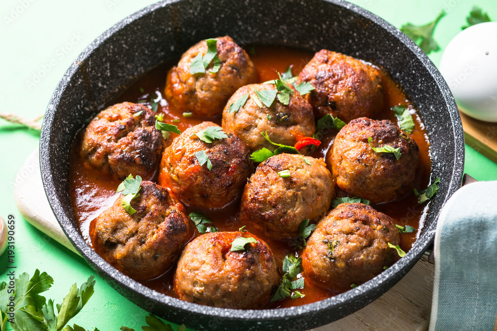 Meat balls in tomato sauce in a frying pan. Meat balls in tomato sauce in a frying pan.