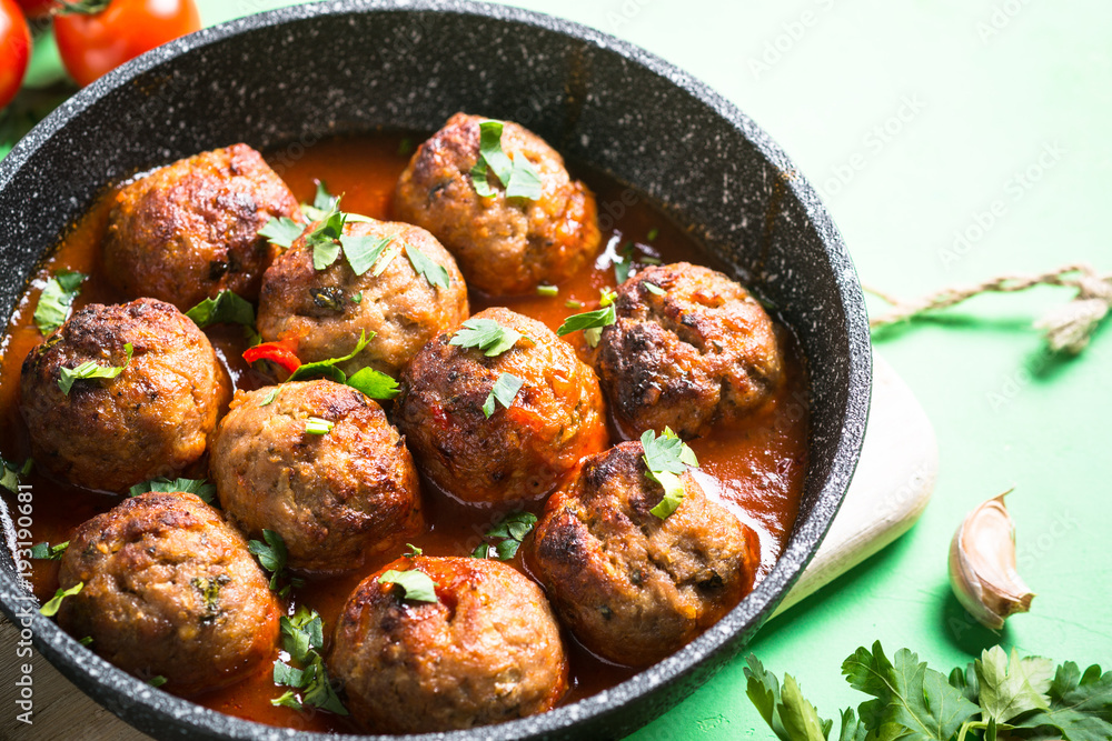 Meat balls in tomato sauce in a frying pan. Meat balls in tomato sauce in a frying pan.