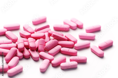 Pink medicine pills on white