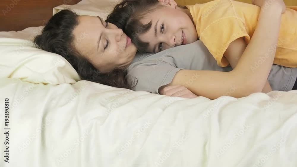 Mom with child on bed. Little girl lies with mum. Mom with child on bed. Little girl lies with mum.