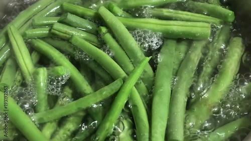 Close up of boiling green string beans in hot water.