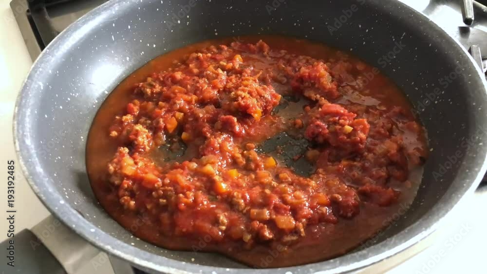 Time lapse of cooking ragù, a typical Italian sauce for pasta with tomato and meat. Time lapse of cooking ragù, a typical Italian sauce for pasta with tomato and meat.